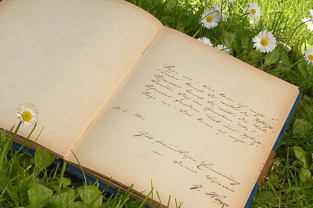 Photo Of Handwritten Poetry Journal On Grass