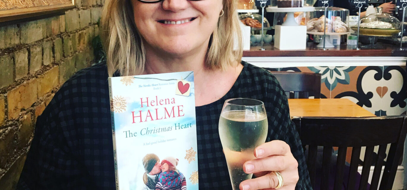 photo of Helena Halme with wine and book
