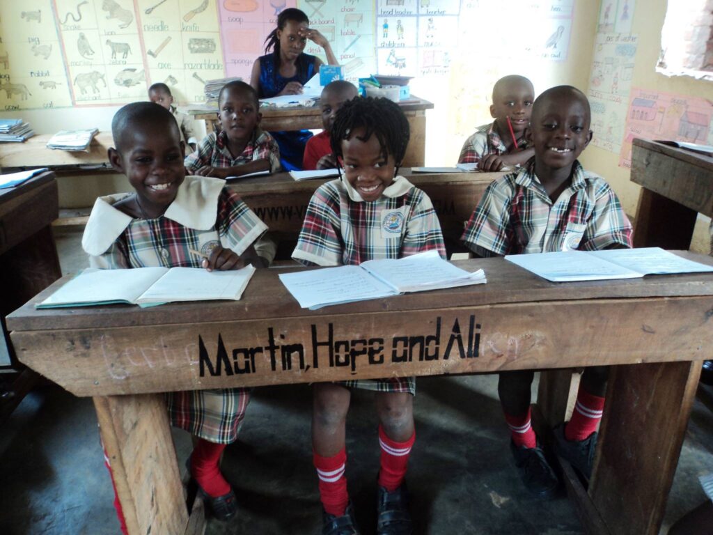 image of school desk in Uganda with author names on it
