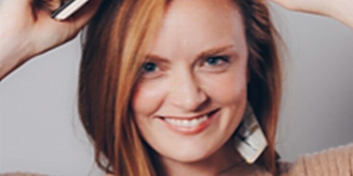headshot of Meghan Harvey with book on her head