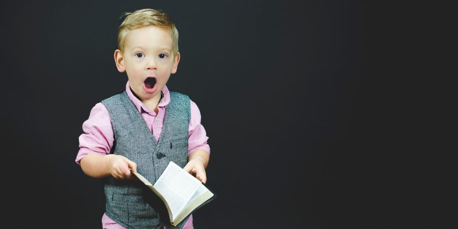 Picture Of Small Boy Startled At What He Has Just Read In A Book