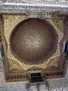 Real Alcazar palace domed roof with intricate gold and maroon tiling in a diamond style pattern