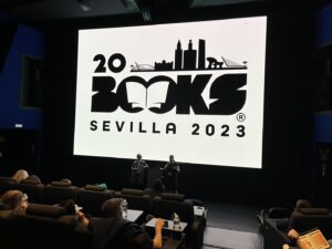 Joanna Penn and Orna Ross presenting on the Creator Economy in front of a large cinema screen with "20books seville 2023" displayed