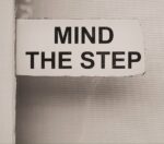 Sign saying 'mind the step' symbolising the challenges of writing with a family member