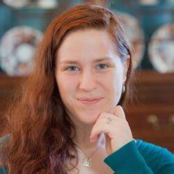Woman With Long Red Hair, Smiling Indoors.